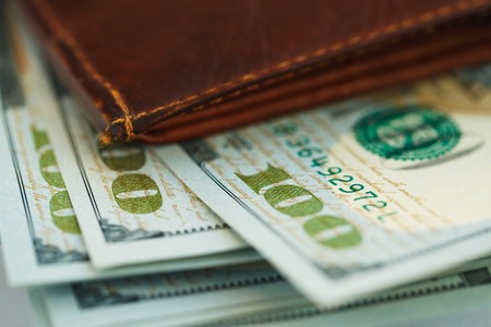 Brown leather wallet with USA dollars money inside itの写真素材