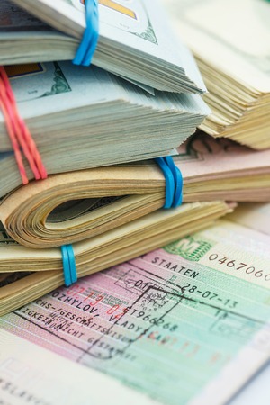 American money is on the top of the opened passport - travel conceptの写真素材