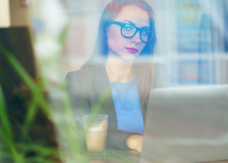 Beautiful young woman working in a cafe - modern business concept