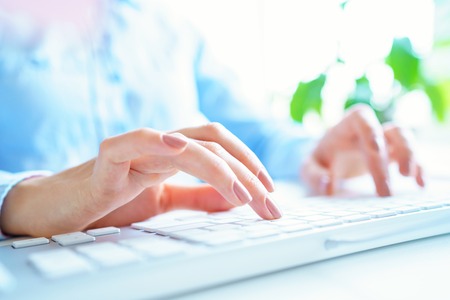 Female hands or woman office worker typing on the keyboardの写真素材