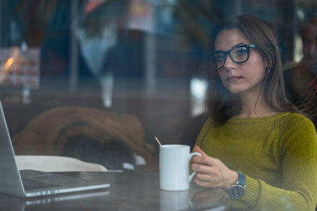 Beautiful young woman working in a cafe - modern business concept