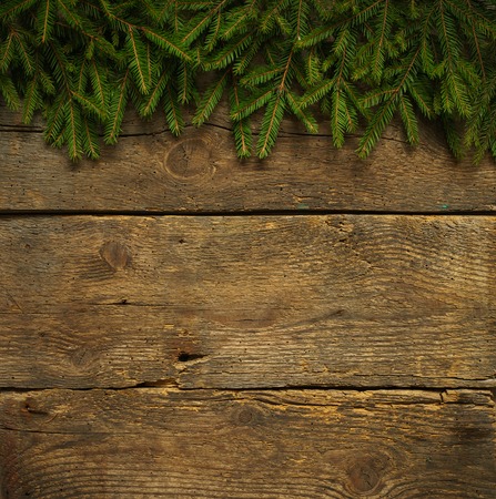 Christmas tree branches on wooden texture. Winter holidays backgroundの写真素材