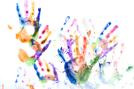A lot of multicolored hand prints on white backgroundの写真素材