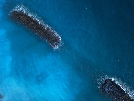Aerial view of the surface of the Atlantic Ocean and breakwaters. Tenerife, Canary Islands, Spainの写真素材