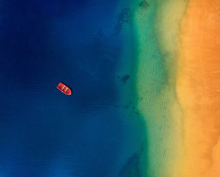 Top view of a lonely red boat anchored off the coast of Las Teresitas beach. Tenerife, Canaries, Spainの写真素材