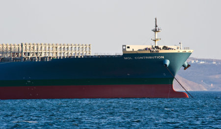 The bow of a huge container ship MOL Contribution anchored. Nakhodka Bay. East (Japan) Sea....
