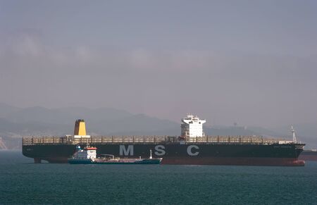 Nakhodka. Russia - March 17, 2019: Bunkering tanker Zaliv Nakhodka large MSC Trieste.のeditorial素材