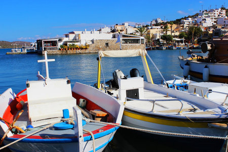 Greek fishing boats are moored at city port.の写真素材