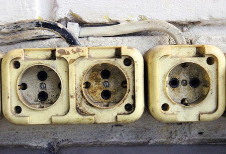 Old dirty sockets on a brick wallの写真素材