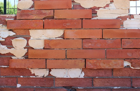 Old destroyed brick wall with cementの写真素材