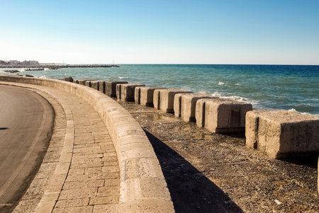 Beautiful seashore road with sea on background in sunset light