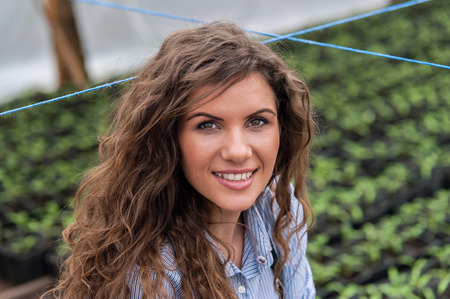 Young woman working in a greenhouse in a greenhouseの写真素材
