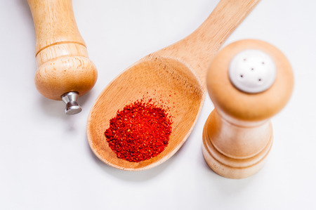 Sweet paprika dust Isolated on White Background in wooden spoonの写真素材