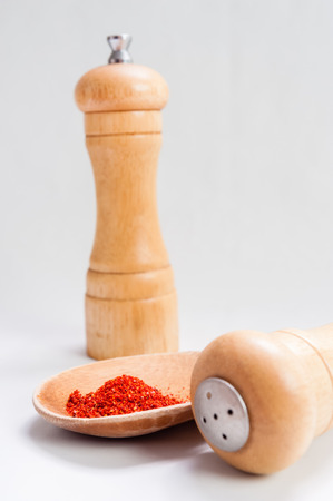 Sweet paprika dust Isolated on White Background in wooden spoonの写真素材