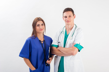 Medical professionals standing isolated. Young caucasian man and young woman nurse in medical scrubsの写真素材