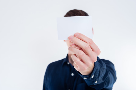 Close-up of white empty business card in business man handの写真素材
