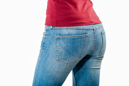 Shot of young woman behind in worn out jeans