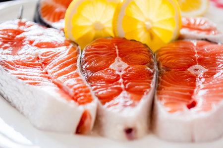 Salmon. Fresh raw salmon red fish steak on a plate with lemon