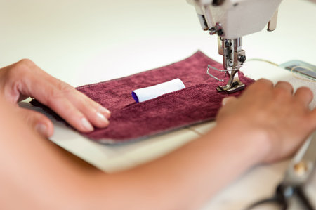 Sewing Process - Women's hands behind her sewing