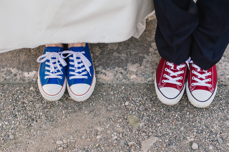 groom and bride in colourful plimsollsの写真素材
