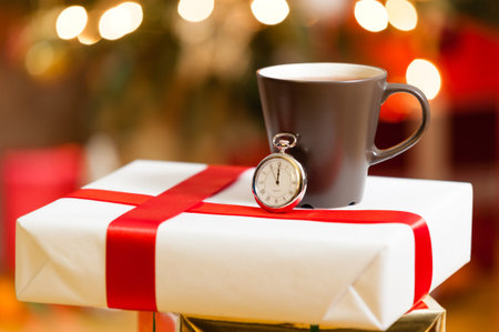 Gift box with christmas decoration on background and pocket watch