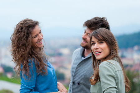Three young friends standing togetherの写真素材