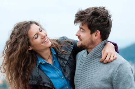 Pretty couple hugging, flirting and laughing.の写真素材