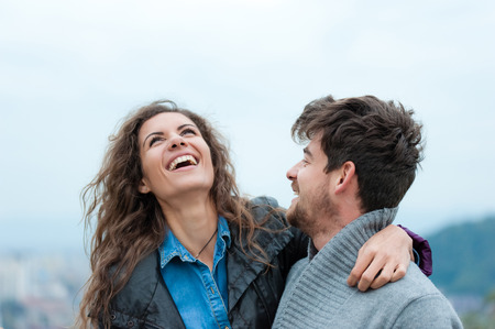 Pretty couple hugging, flirting and laughing.の写真素材