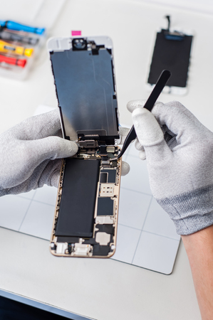 Close-up photos showing process of mobile phone repair, changing the screen.の写真素材
