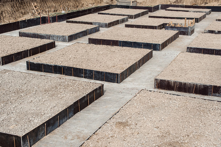 Concrete foundation blocks for a new building on a construction siteの写真素材