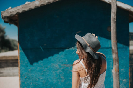 Smiling, pretty hipster traveler girl with windy hair. Artistic photo of young hipster traveler girl...