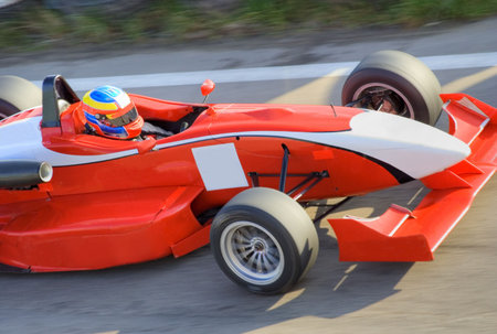 Red racing formula car in motionの写真素材