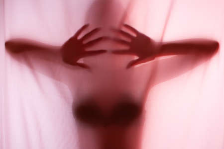 Silhouette of girl behind a curtain. Abstract and blurred image of a girlの写真素材