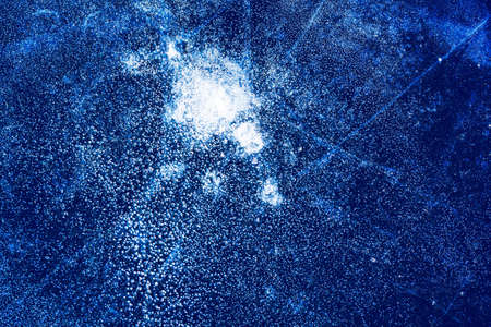 Ice texture with frozen bubbles and cracks on a dark blue background. Beautiful abstract decorative background. Stylish abstract design for wraps, gift, fabric, textile, furnishing. Winter pattern.の写真素材