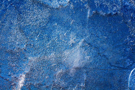 Ice texture with frozen bubbles and cracks on a dark blue background. Beautiful abstract decorative background. Stylish abstract design for wraps, gift, fabric, textile, furnishing. Winter pattern.の写真素材