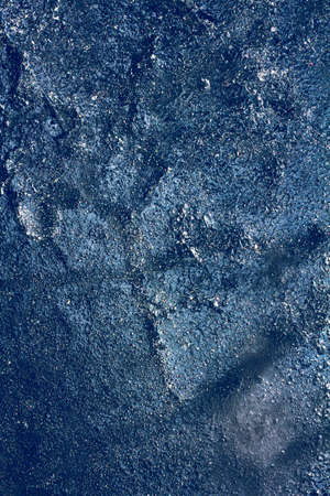 Ice texture with frozen bubbles and cracks on a dark blue background. Beautiful abstract decorative background. Stylish abstract design for wraps, gift, fabric, textile, furnishing. Winter pattern.の写真素材