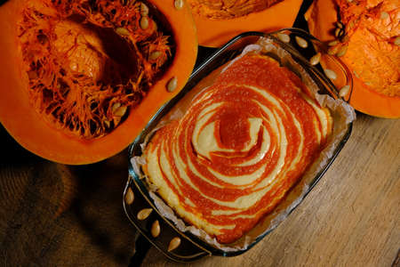 Homemade pumpkin pie cheesecake with piece of pumpkin. Orange dessert. vertical image. top view. PLACE FOR TEXTの写真素材