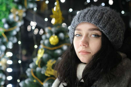 young beautiful happy Face of smiling girl posing. Christmas tree Happy New Year eating Chocolate with coffee cupの写真素材