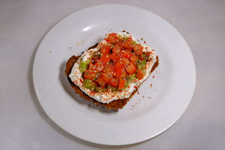 Avocado sandwiches, half of avocado, with peanuts and pumpkin seeds, tomatoes on a white background texturedの写真素材