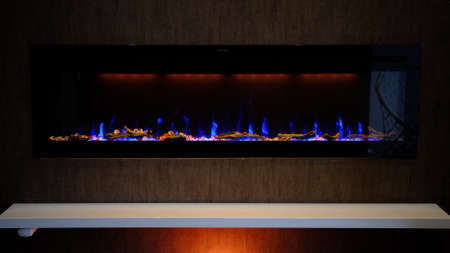 view on electric fireplace with artificial sparkling flame, decor for the interior, blue flame on crystals with orange backlighting.の写真素材