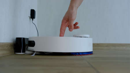 Cleaning the filter of the vacuum robot cleaner from dirt, take it out for cleaning.の写真素材