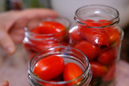 Homemade pickled tomatoes in glass jars Fermented tomatoes in transparent glass. Homemade canned...