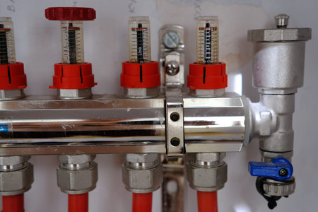 Heating system manifold valves for heat flooring and water supply in a country house. Pipes...