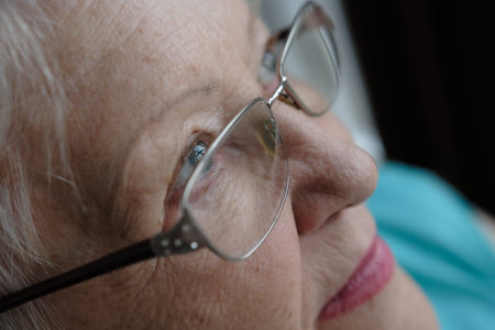 Close up portrait of senior woman with gray eye's looking at the camera in glasses