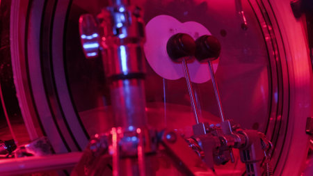 Drummer rehearsing on drum barrel before rock concert. Man recording music on drum set in studio in red light.の写真素材