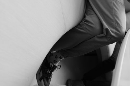 pair of legs in socks with a dollar pattern, black and white photo of the modern man in pants shoes and soks with dollar paternの写真素材