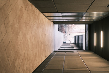 Long tunnel with mirrors in modern city architecture with low lights and grey colors with tile on the frloorの写真素材