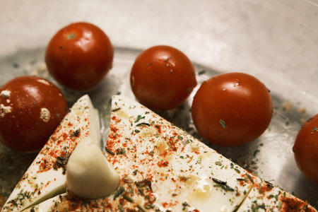 Cheese Mozzarella with spices garlic and tomato in a glass bowlの写真素材