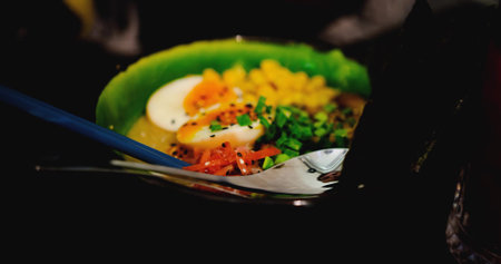 delicious bowl of ramen, featuring corn, seaweed, noodles, eggs, and meat. Close-up shot captures...