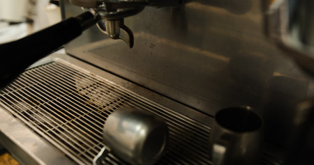 Dirty professional metal coffee machine with coffee grounds remnants close up on countertop espresso machine stains in kitchen barista workspace used for brewing coffee fresh espresso machine cleanupの写真素材